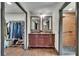 Bathroom features a double sink vanity, framed mirrors, and a walk-in shower at 1801 Sagebrush Rd, Plant City, FL 33566