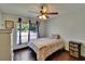 Cozy bedroom features a ceiling fan, wood look floors, and a window at 1801 Sagebrush Rd, Plant City, FL 33566