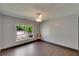 Bedroom features wood look floors, ceiling fan, a window, and neutral paint at 1801 Sagebrush Rd, Plant City, FL 33566
