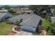 Picture-perfect single-story home featuring a well-maintained lawn, mature trees, and an attached two-car garage at 1801 Sagebrush Rd, Plant City, FL 33566