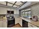 Modern kitchen with stainless steel appliances, granite countertops, and pool view at 1801 Sagebrush Rd, Plant City, FL 33566