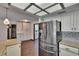 Well-lit kitchen with stainless appliances, white cabinets, and wood floors at 1801 Sagebrush Rd, Plant City, FL 33566