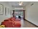 Bright living room with red couch, wood floors and view of pool at 1801 Sagebrush Rd, Plant City, FL 33566