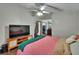 Bright main bedroom features ceiling fan, television, walk-in closet, and ensuite bathroom at 1801 Sagebrush Rd, Plant City, FL 33566