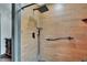 Walk-in shower features wood look tiles and a rainfall shower head at 1801 Sagebrush Rd, Plant City, FL 33566