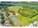 Aerial view showcasing the community's recreational facilities, with baseball fields, tennis courts, and waterfront access at 1809 Elmwood Dr, Oldsmar, FL 34677