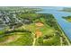 Aerial shot featuring community baseball fields and tennis courts near residential area with trees, and access to the waterway at 1809 Elmwood Dr, Oldsmar, FL 34677