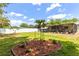 Well-maintained backyard featuring a screen enclosed patio and tidy landscaping provides a serene outdoor experience at 1809 Elmwood Dr, Oldsmar, FL 34677