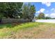 The large backyard features a combination of green grass, mature trees, and privacy fencing, creating a serene outdoor oasis at 1809 Elmwood Dr, Oldsmar, FL 34677