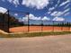 This image showcases a chain link fenced in baseball diamond on a sunny day at 1809 Elmwood Dr, Oldsmar, FL 34677