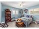 Comfortable bedroom with ample natural light, stylish furnishings, and soothing blue walls at 1809 Elmwood Dr, Oldsmar, FL 34677