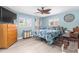 Comfortable bedroom featuring a plush bed, dresser, and bright, shuttered windows at 1809 Elmwood Dr, Oldsmar, FL 34677