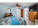 A relaxing bedroom with blue walls, wood accents and a large window for a bright and airy feel at 1809 Elmwood Dr, Oldsmar, FL 34677