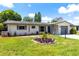 Charming single story home with a manicured lawn and beautiful landscaping at 1809 Elmwood Dr, Oldsmar, FL 34677