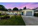 Charming home at dusk with a well-maintained lawn, beautiful landscaping, and inviting curb appeal at 1809 Elmwood Dr, Oldsmar, FL 34677