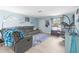 Cozy living room featuring a comfortable gray sofa, plush blue rug, and inviting decor at 1809 Elmwood Dr, Oldsmar, FL 34677