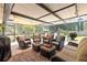 The covered, screened patio features ample seating, providing an inviting space for outdoor relaxation and entertainment at 1809 Elmwood Dr, Oldsmar, FL 34677