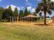 This image showcases monkey bars and a covered picnic area on a playground at 1809 Elmwood Dr, Oldsmar, FL 34677