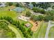 Aerial view featuring tennis court, basketball court, playground and gazebo in a park setting at 1809 Elmwood Dr, Oldsmar, FL 34677