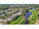 Scenic aerial view of homes lining a golf course with lush green fairways and a serene water feature at 18107 Canal Pointe St, Tampa, FL 33647