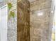 Modern bathroom showcasing a tiled shower with updated fixtures and decorative accents on the adjacent wall at 18107 Canal Pointe St, Tampa, FL 33647