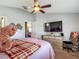 Bedroom showcases a cozy bed, ceiling fan, television, dresser, and versatile interior space at 18107 Canal Pointe St, Tampa, FL 33647