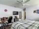Bedroom with a TV, desk setup, neutral walls, and ceiling fan provide a study and comfortable retreat at 18107 Canal Pointe St, Tampa, FL 33647