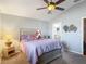Charming bedroom with a cozy bed, ceiling fan, and bedside lamp, creating a relaxed and inviting atmosphere at 18107 Canal Pointe St, Tampa, FL 33647