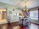 Cozy dining area features wood floors, an elegant chandelier, and a view to the kitchen at 18107 Canal Pointe St, Tampa, FL 33647