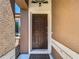 Close-up of the beautiful dark brown front door with a welcome mat and security features at 18107 Canal Pointe St, Tampa, FL 33647
