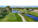 Picturesque golf course view featuring a water hazard, footbridge, and pristine green, surrounded by mature trees at 18107 Canal Pointe St, Tampa, FL 33647