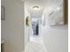 Hallway featuring neutral colors, tile flooring, decorative art and archway at 18107 Canal Pointe St, Tampa, FL 33647