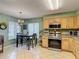 Eat in kitchen offers tile floors, stainless steel appliances, neutral countertops, and a view of the backyard at 18107 Canal Pointe St, Tampa, FL 33647