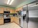 Kitchen featuring stainless steel appliances, wood cabinets, and modern design elements at 18107 Canal Pointe St, Tampa, FL 33647