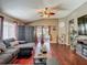 Comfortable living room with vaulted ceilings, wood floors, large sofa, and sliding glass doors at 18107 Canal Pointe St, Tampa, FL 33647