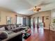 Comfortable living room with vaulted ceilings, wood floors, large sofa, and sliding glass doors at 18107 Canal Pointe St, Tampa, FL 33647