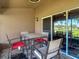 Inviting screened patio with a table and chairs, offering views of the lush backyard and scenic surroundings at 18107 Canal Pointe St, Tampa, FL 33647