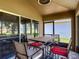 Inviting screened patio with a table and chairs, offering views of the lush backyard and scenic surroundings at 18107 Canal Pointe St, Tampa, FL 33647