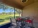 Inviting screened patio with a table and chairs, offering views of the lush backyard and scenic surroundings at 18107 Canal Pointe St, Tampa, FL 33647