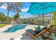 Landscaped backyard with a freeform pool, lounge chairs, and a covered patio perfect for outdoor entertaining at 1827 Oregon Ne Ave, St Petersburg, FL 33703