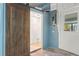 Basement bathroom is complete with a sliding barn door and a window that brings in natural light at 1827 Oregon Ne Ave, St Petersburg, FL 33703