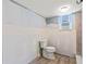 Bathroom with a toilet, tile floor, and a window bringing in light at 1827 Oregon Ne Ave, St Petersburg, FL 33703