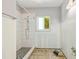 Bathroom complete with tiled shower, updated fixtures and a window that brings in natural light at 1827 Oregon Ne Ave, St Petersburg, FL 33703