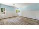 Spacious bedroom with light from multiple windows and original wood floors at 1827 Oregon Ne Ave, St Petersburg, FL 33703