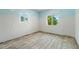 Bedroom is filled with natural light from multiple windows and original wood floors at 1827 Oregon Ne Ave, St Petersburg, FL 33703