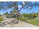 Attractive single story home with a well-maintained lawn, gated front yard, and convenient driveway at 1827 Oregon Ne Ave, St Petersburg, FL 33703