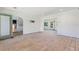 Open-concept room showcasing natural light, hardwood flooring, and arched doorway, ready for renovation at 1827 Oregon Ne Ave, St Petersburg, FL 33703