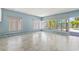 Living room boasts many windows and a sliding glass door leading out to the patio at 1827 Oregon Ne Ave, St Petersburg, FL 33703