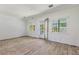 Awaiting new life, an expansive living space features hardwood floors and multiple windows at 1827 Oregon Ne Ave, St Petersburg, FL 33703