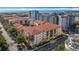 Aerial view showcasing condo buildings with red tile roofs and ocean view in the background at 200 4Th S Ave # 229, St Petersburg, FL 33701